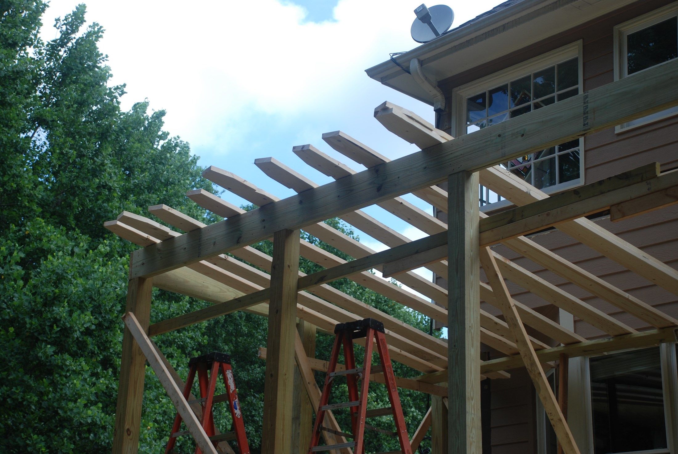 Decks.com. Building a shed roof over a deck